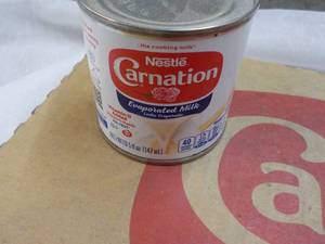lot 148 image: 24 ct 5 oz Cans Nestles Carnation Evaporated Milk - best date 08312023