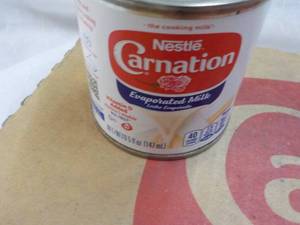 lot 149 image: 24 ct 5 oz Cans Nestles Carnation Evaporated Milk - best date 08312023