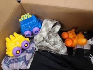 Box of childrens toys and mens clothes.