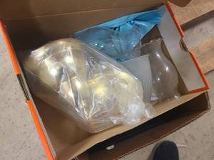 Box of household items, shoes, light fixtures and more.