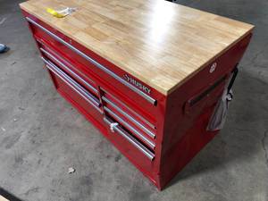 lot 27 image: Husky 52 in. W x 25 in. D Standard Duty 9-Drawer Mobile Workbench Cabinet with Solid Wood Top in Gloss Red side damage see pictures customer return