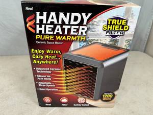 lot 131 image: New Handy Heater Pure Warmth Ceramic Space Heater