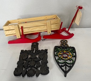 lot 70 image: Small Wooden Sled and Two Cast Iron Trivets