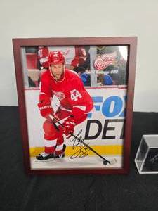 lot 19 image: Framed Autographed 8x10 Photo of Red Wings Todd Bertuzzi, Rick Comley Signed Hockey Puck & MN Timberwolves Lunchbox w Thermos