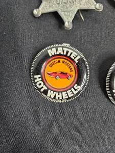 lot 11 image: LBJ 1964 VTG Campaign Pinback Button, Pair of Mattel Hot Wheels Silhouette Fold Over Pin Buttons, Wyatt Earp Toy Marshal Badge