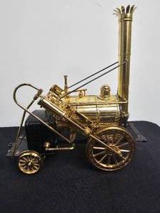 lot 206 image: VTG Brass Robert Stephensons Rocket Train Locomotive Model, Lenox Sweet Little Devil A Halloween Dog, VTG Kinetic Green Clown Pendulum Twirl on Chrome Wire Stand & More