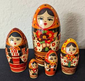 lot 53 image: Three Painted Wood Russian Nesting Doll Sets
