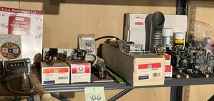 lot 426 image: Cadillac Spare Parts Lot - Carburetor, Delco Parts, Rotary Drum Clock and More