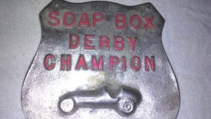 lot 27 image: Boy Scout Cast Aluminum Soap Box Derby Champion.