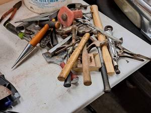 lot 244 image: Lot of (1 Bucket) Assorted Hammers, Chisels, Pliers, Wood Replacement Handle, Square, Misc. Tools