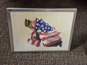 lot 494 image: Wall Art - Kneeling Soldier with American Flag by Andrew Wanshum Signed circa 2002 , Framed