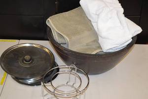 lot 23 image: Fondue Bowl Stand, Assorted Pot Lids, Large Wooden Bowl, Towels