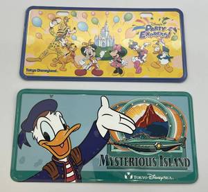lot 128 image: Vintage Collectible TOKYO Disneyland Party Express & Mysterious Island License Plates (New Factory Sealed In Plastic Sleeve)