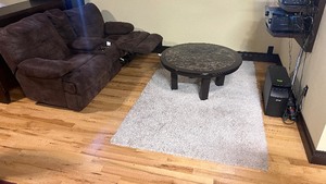 lot 25 image: 42 inch round coffee table and area rug.