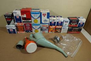 Assorted Automotive Oil Filters and Vintage Funnels