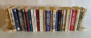 lot 5 image: Lot of 25 Louis LAmour Western Books with Alabaster Horse Head Bookend Set