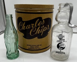 lot 89 image: Vintage Charles Potato Chip Tin, Marigold Dairy Bottle and Separator Spoon Coke Bottle