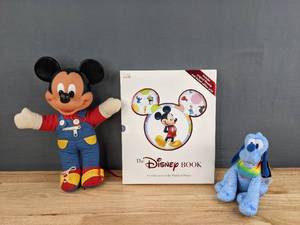 lot 149 image: Vintage Learn to Dress Myself Mickey Mouse, BlueRainbow Pride Pluto, and Hardcover Copy of The Disney Book R
