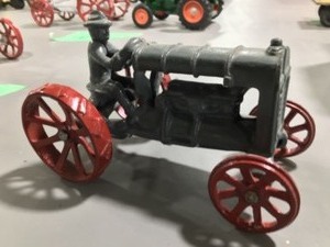 light grey ertl Fordson tractor 116 and a dark gray tractor with driver 124