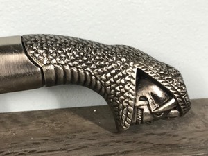 lot 51 image: Stainless Steel Knife with a Snake Pictured on the Blade and with a Snake Head Biting Down on a Skull on the Handle