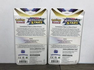 lot 326 image: POKEMON BRILLIANT STARS Flapple & Eevee Booster Packs (Unopened packs with coin in the front)