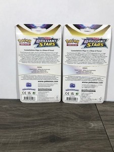 lot 325 image: POKEMON BRILLIANT STARS Flapple & Eevee Booster Packs (Unopened packs with coin in the front)