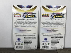 lot 324 image: POKEMON BRILLIANT STARS Flapple & Eevee Booster Packs (Unopened packs with coin in the front)