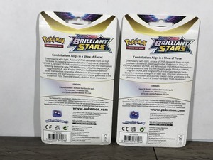 lot 323 image: POKEMON BRILLIANT STARS Flapple & Eevee Booster Packs (2 - Unopened packs with coin in the front)