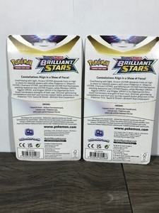 lot 322 image: POKEMON BRILLIANT STARS Flapple & Eevee Booster Packs (2 - Unopened packs with coin in the front)