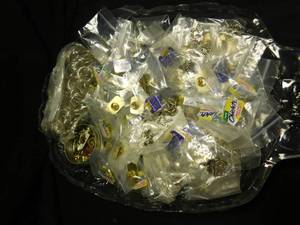 lot 321 image: Glass tray of advertised pins, earrings, and keychain rings.
