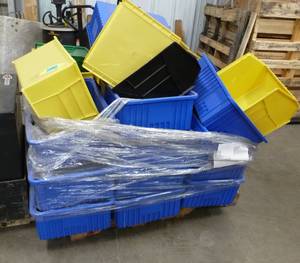 Pallet full of plastic storage bins