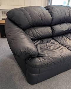 lot 27 image: Navy Blue Leather Loveseat