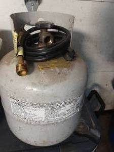 lot 39 image: empty 20lb propane tank with conversion hose