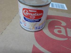 lot 297 image: 24 ct 5 oz Cans Nestles Carnation Evaporated Milk - best date 08312023