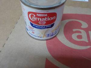 lot 299 image: 24 ct 5 oz Cans Nestles Carnation Evaporated Milk - best date 08312023