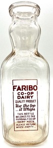 lot 145 image: Vintage FARIBO CO-OP DAIRY Use the top.. it Whips One Quart Bottle with Cream Top Spoon from the 1920s