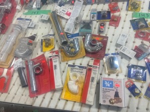TABLE FULL OF PLUMBING PARTS