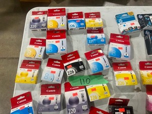 TABLE FULL OF PRINTER INK CARTRIDGES