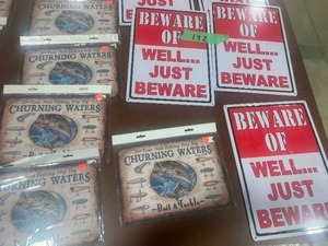 TABLE FULL OF METAL SIGNS