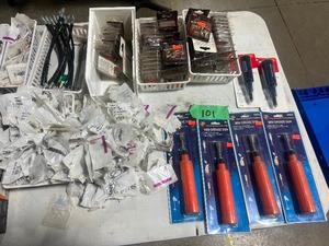 TABLE FULL OF GREASE GUNS, FITTINGS, & HOSES