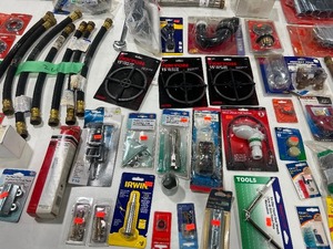 TABLE FULL OF PIPE CUTTERS, TIMMER SWITCHES, DRAIN & PIPE SNAKES, & MISC. PLUMBING ITEMS