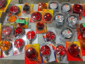 TABLE FULL OF TAILLIGHT KITS FOR TRAILERS, SINGLE FACE STOPTURNTAIL LIGHTS, & SPOT LIGHTS