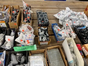 TABLE FULL OF ELECTRICAL CONDUIT CLAMPS & CIRCUIT BREAKER CENTERS