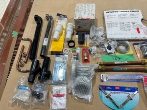 TABLE FULL OF PLUMBING PARTS