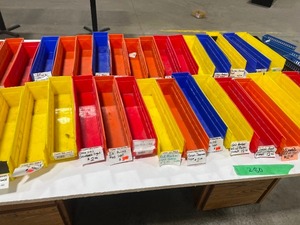 TABLE FULL OF PLASTIC STORAGE TOTES