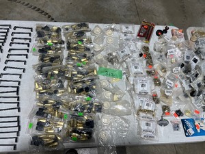 TABLE FULL OF DRAWER PULLS & FLOOR PROTECTORS