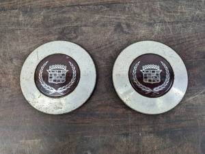 lot 94 image: Pair Of Metal Cadillac Hubcaps