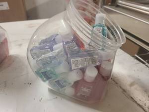 Small cannister of sample size hand sanitizers