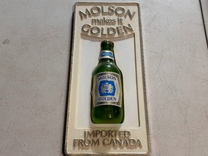 lot 291 image: Rare Vintage Molson Golden Plastic Sign - Molson Makes it Golden.  15 x 7