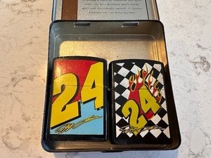 lot 200 image: Two Vintage #24 Jeff Gordon Camel Zippo Lighters in Camel Spice Cinnzabar Tin